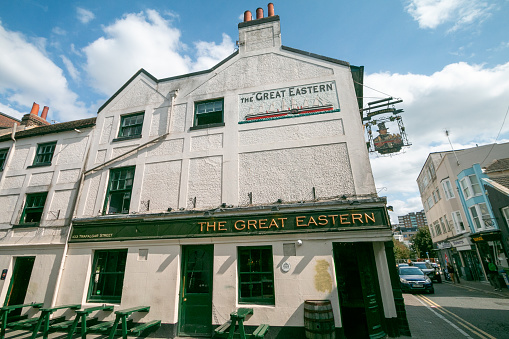 The Great Eastern Pub on Trafalgar Square in Brighton, England, with cars and number plates visible on the roadside