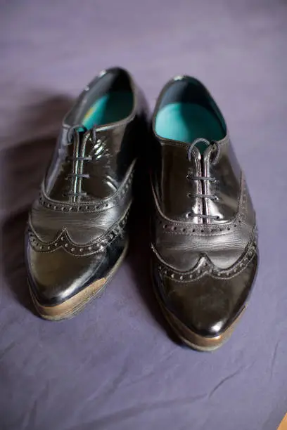 Pair of ladies black leaher wingtip shoes ready to be worn by woman on her same sex wedding dayPair of ladies black leather wingtip shoes ready to be worn by woman on her same sex wedding dayPair of ladies black leather wingtip shoes ready to be worn by woman on her same sex wedding day
