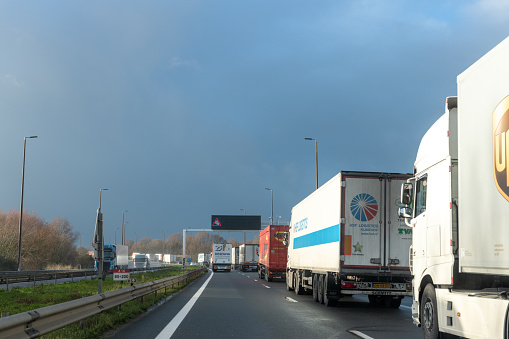 Calais, France - December  17, 2020 : As brexit approaches, lines of trucks at the entrance to the Channel Tunnel