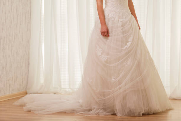 istock Low section of beautiful wedding dress on a bride 1292702129