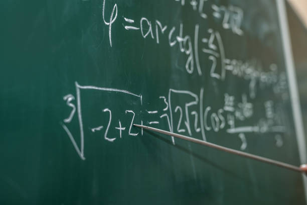 istock female hand showing math formula in chalkboard. Back to school 1292704657