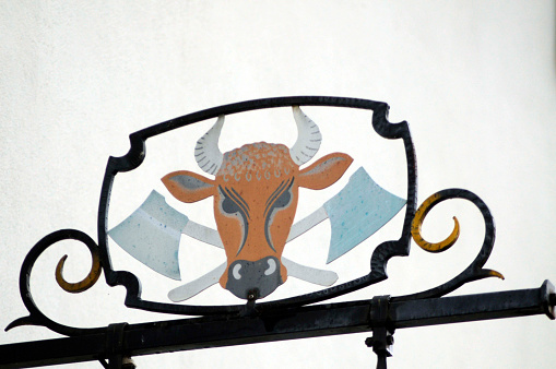 a butcher shop sign with the head of a cow