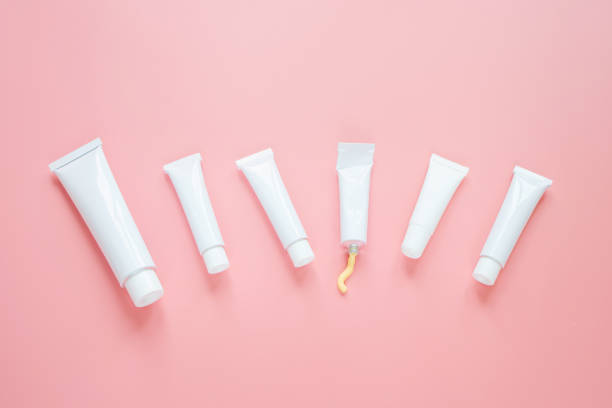 istock White cosmetic tubes on a pink background. 1292708163