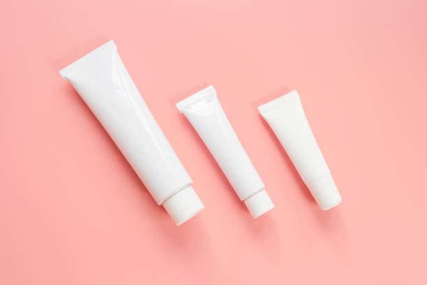 istock White cosmetic tubes on a pink background. 1292708182