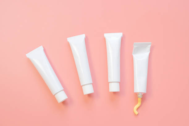 istock White cosmetic tubes on a pink background. 1292708196