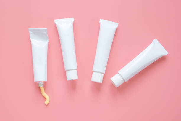 istock White cosmetic tubes on a pink background. 1292708201
