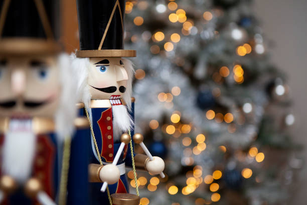 istock Soldier nutcracker statues in front of decorated Christmas tree with blurred lights 1292712705