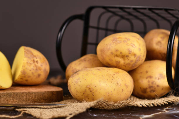 istock Whole raw potatoes with peel in metal basket 1292713830