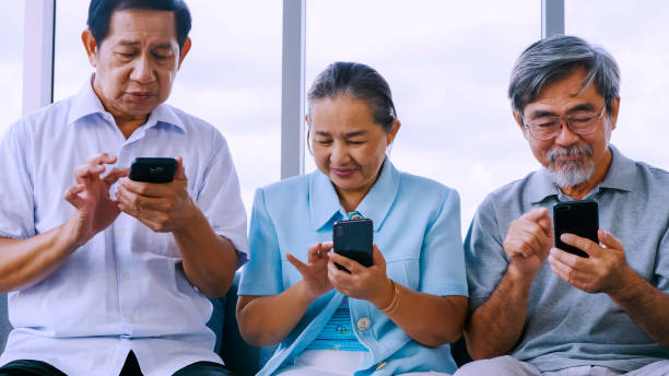 istock Group of senior friends using smart phone in a retirement home 1292714130