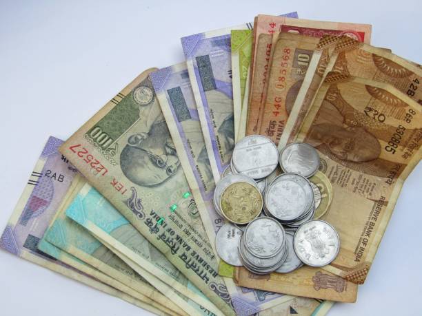 istock Indian rupees coins with some Indian currency notes stock photo 1292717331