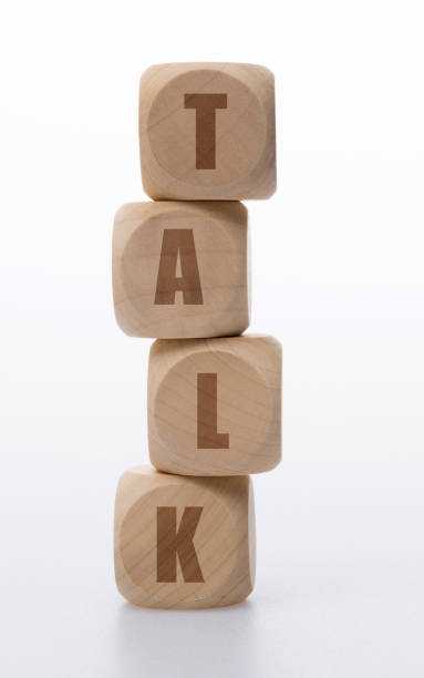 istock Wooden cubes with word talk on white background 1292717470