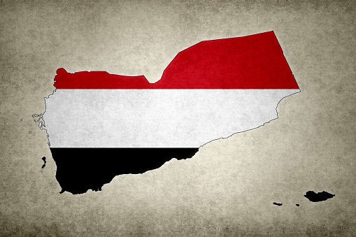 Grunge map of Yemen with its flag printed within its border on an old paper.