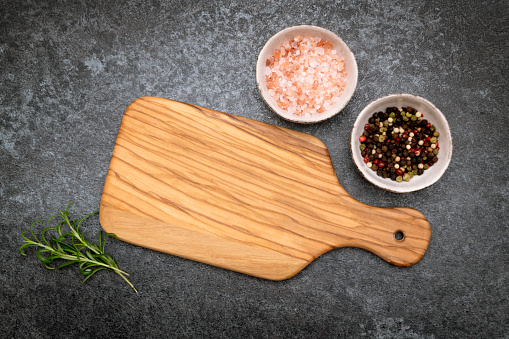 Cutting board with spaces on wooden table. Top View