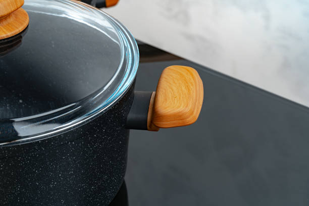 istock Black cookware on induction stove against grey wall 1292721063