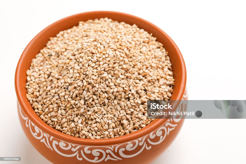 Sesame seed in bowl on white background Makar Sankranti Stock Photo