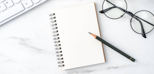 istock Top view of office table desk cozy work concept on bright marble white background. 1292721696