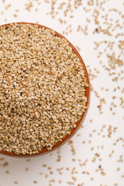 istock Sesame seed in bowl on white background 1292721703