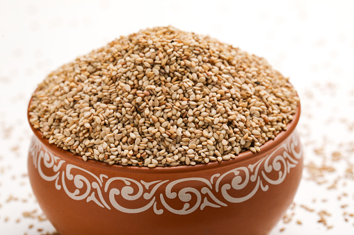 sesame in a white bowl on wood