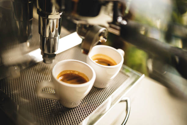 istock two cups of espresso being poured from an espresso machine 1292721740