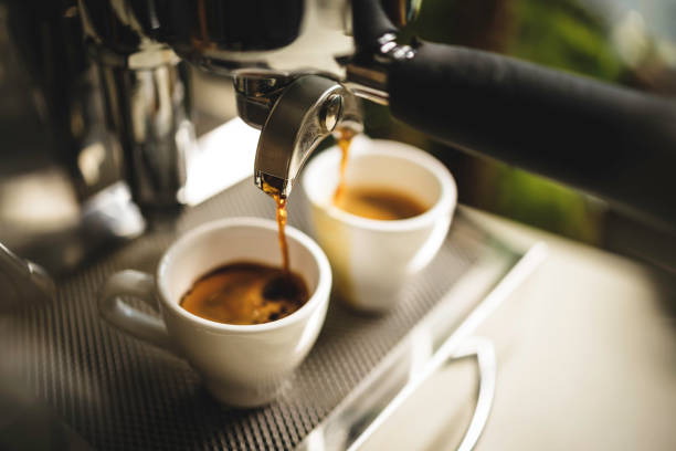 istock two cups of espresso being poured from an espresso machine 1292722580