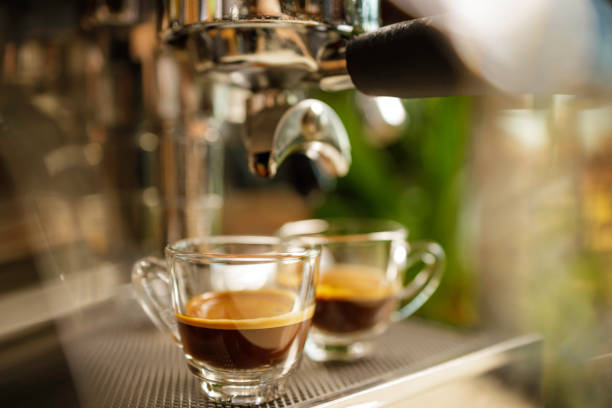 istock two cups of espresso being poured from an espresso machine 1292722582