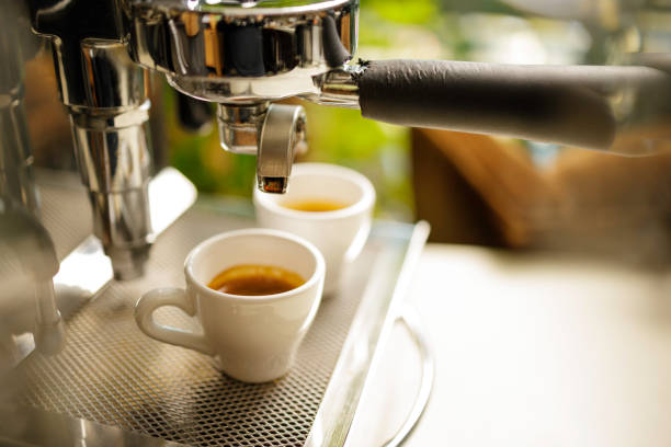 istock two cups of espresso being poured from an espresso machine 1292722590