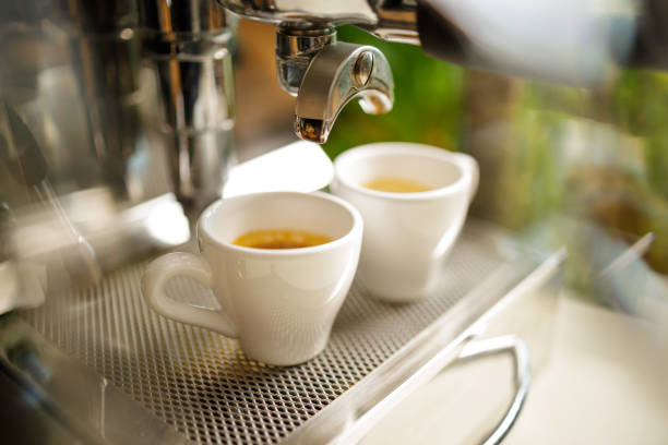 istock two cups of espresso being poured from an espresso machine 1292722592
