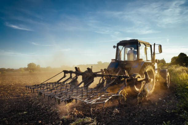 istock The tractor plows the land. Agriculture image 1292722741