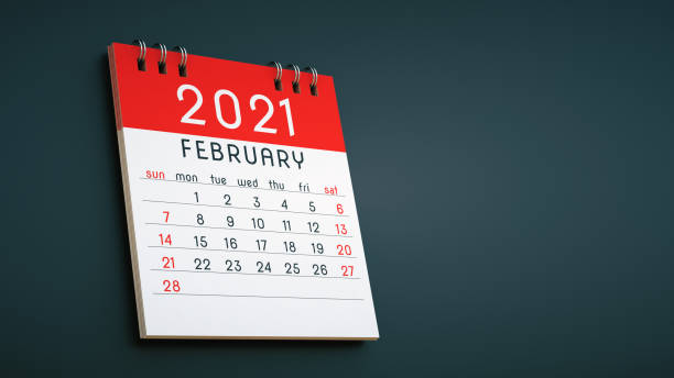 istock February 2021 calendar page notepad in red colors, hanging on a dark gray background 1292723612