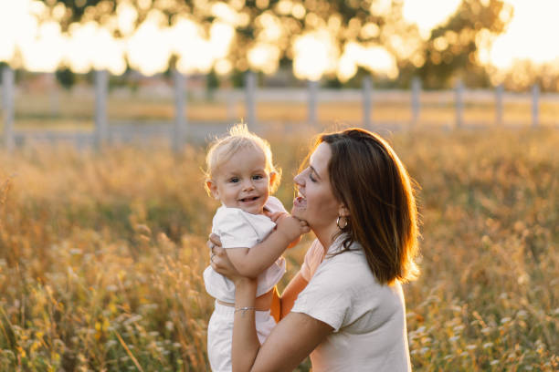 istock Woman playing with her child on the field during sunset. 1292723708
