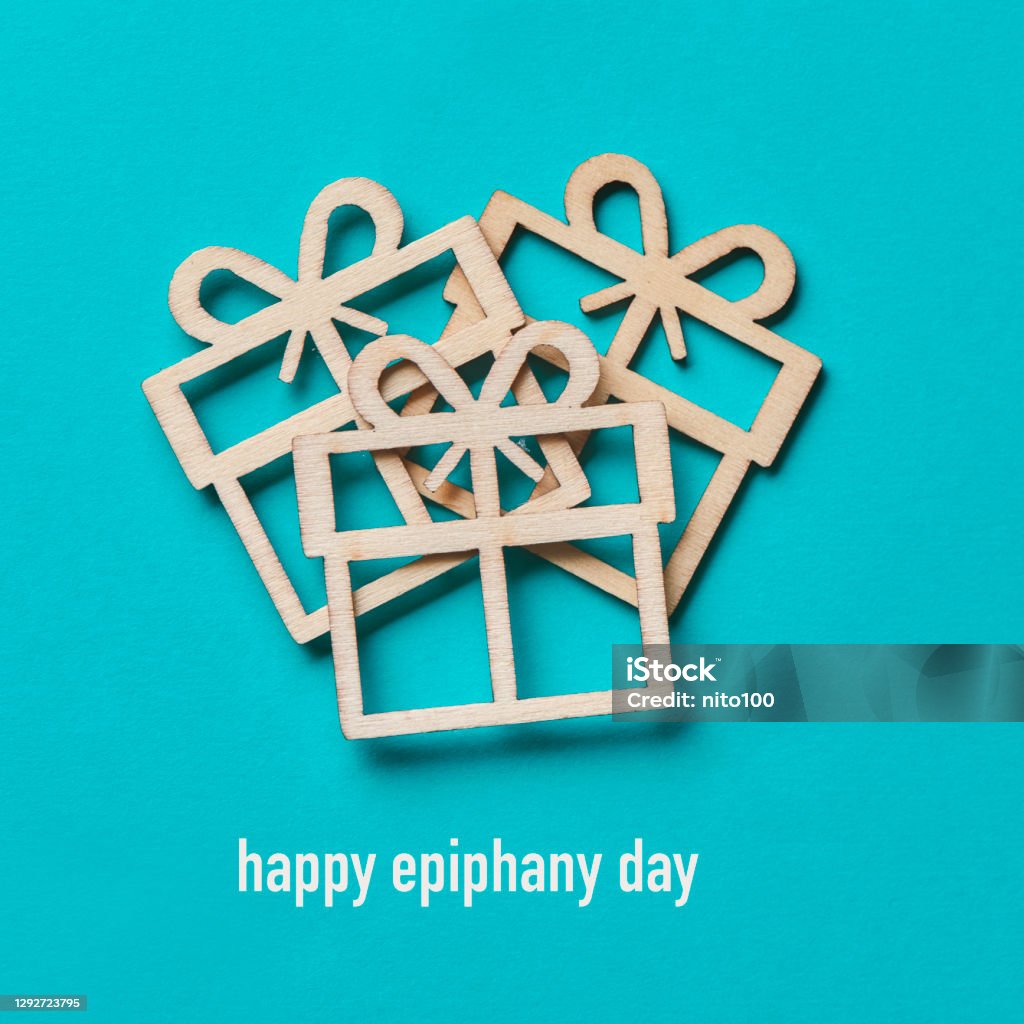 gifts and text happy epiphany day some gifts cut out on wooden and the text happy epiphany day on a blue background Epiphany - Religious Celebration Stock Photo