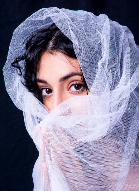 istock Beautiful woman  with white veil  on black background 1292724977