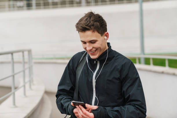 istock Happy young sportive man walking on stadium 1292725388