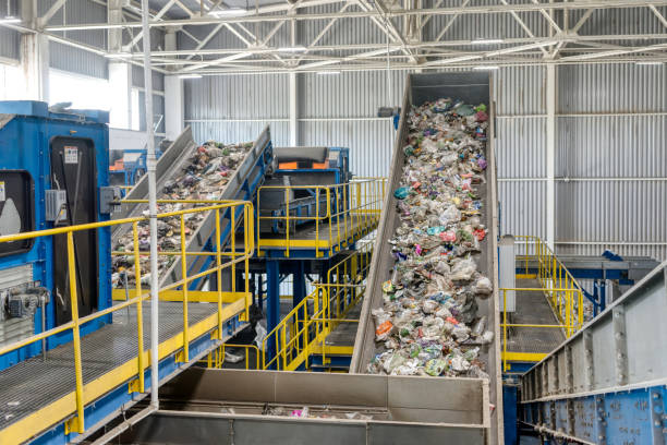 istock Waste sorting and recycling plant. Garbage moves on a conveyor belt 1292726466