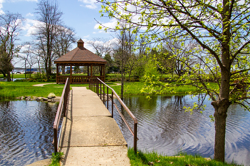 Pavilion and footbridge over a small pond with a wooden gazebo in the small Upper Peninsula town of Gladstone near Escanaba, Michigan.