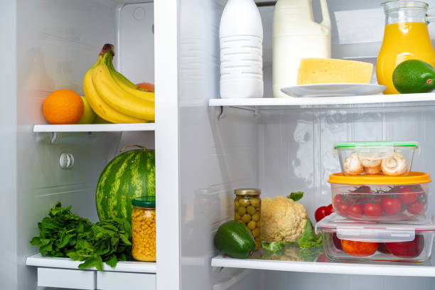 istock Open fridge full of fruits, vegetables and drinks 1292729563