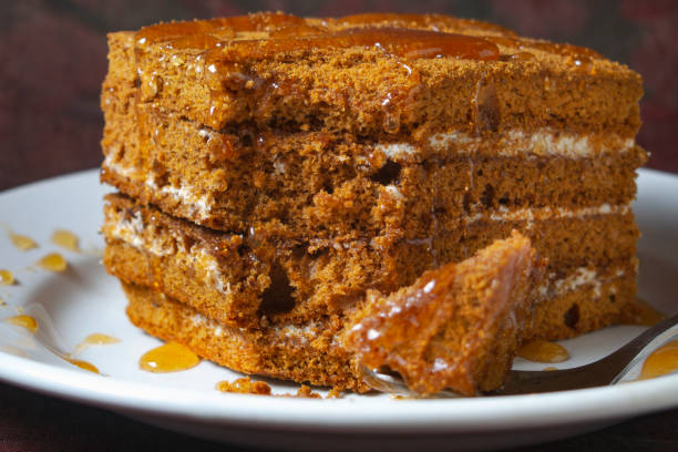 istock honey cake with honey drips lies on a white plate 1292729765
