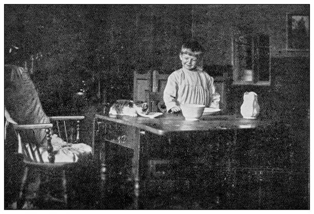 istock Antique dotprinted black and white photograph: Boy and kitten 1292730775