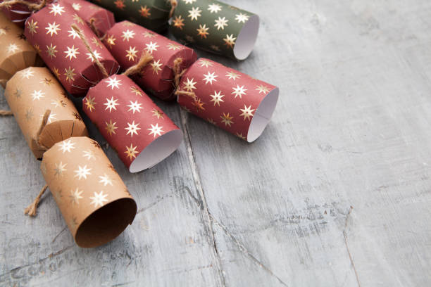 istock Matt paper Christmas crackers on a grey wooden surface with copy space 1292731118
