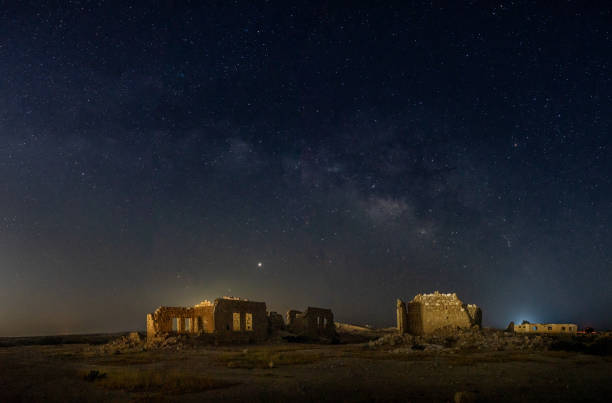 istock Old village ruins under Milky Way 1292731799
