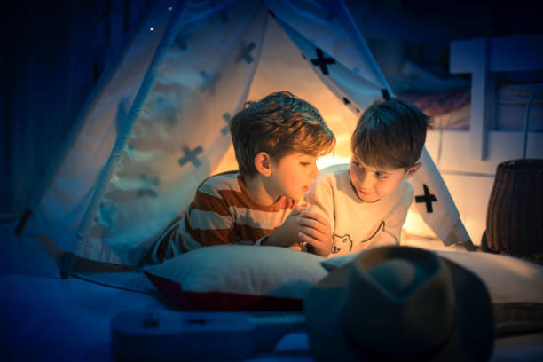 istock Cute kids play camping in kids room 1292732123