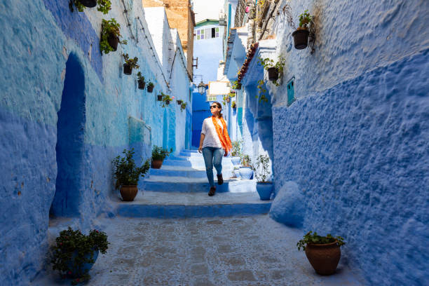 Narrow streets and blue painted houses of Chefchaouen city, Morocco. Narrow streets and blue painted houses of Chefchaouen city, Morocco. Most of the streets full of handmade colorful crafts,carpets and souvenir hanged to the walls of the blue houses. chefchaouen photos stock pictures, royalty-free photos & images
