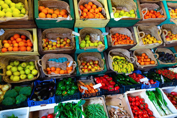 View of showcase with fresh ripe fruits and vegetables in greengrocery