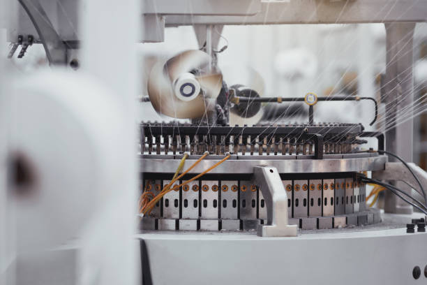 Textile Manufacturing. Circular knitted fabric. Textile factory in spinning production line and a rotating machinery and equipment production company. Clothing industry. Manufacturing textile fabrics. stock photo