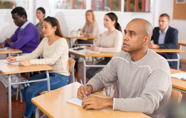 istock Focused man working at adult education class 1292734747