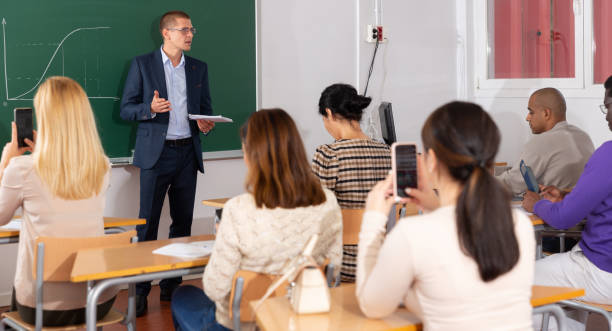 istock Teacher explaining new theme to adult students 1292734763