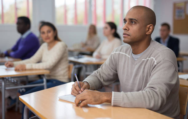 istock Hispanic man listening lecture during adult education class 1292734809