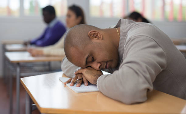 istock Tired bored adult man sleeping during lesson 1292734820