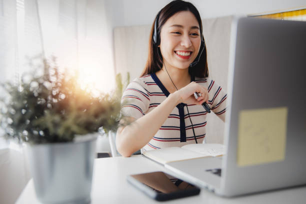 Asian woman teacher teach, talk with student in class lesson online, at home, locking down, stop learning at school, beautiful girl use VDO conference to work and chat, Coronavirus, covid 19 concept Asian woman teacher teach, talk with student in class lesson online, at home, locking down, stop learning at school, beautiful girl use VDO conference to work and chat, Coronavirus, covid 19 concept online tutors stock pictures, royalty-free photos & images