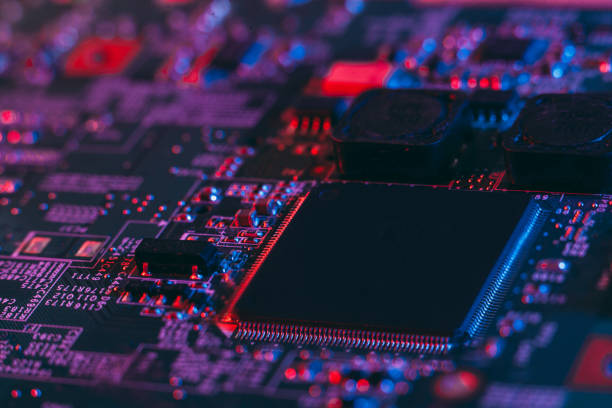 istock Hardware technology concept in neon light. Motherboard in blue-red light. 1292735516